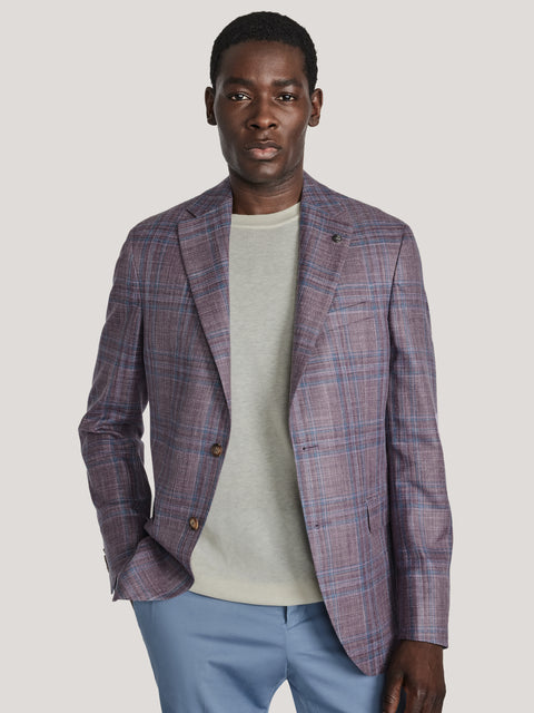 Purple and blue plaid blazer with notched lapels and two-button front worn over cream t-shirt.