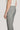 Grey single pleat trouser with button closure and front crease, shown from side view on model.