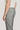 Grey single pleat trouser with front crease and button closure, shown on model from side.