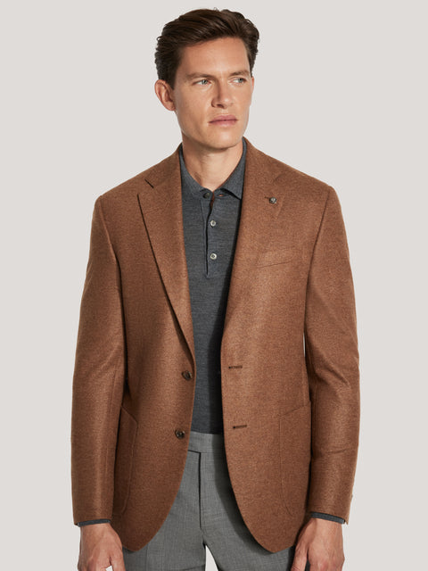 Cognac melange blazer with notch lapels and button front, worn over gray polo shirt and gray trousers.
