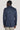 Denim blue melange blazer with notch lapels and long sleeves, shown from back on model.