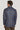 Man wearing blue and brown plaid blazer, shown from back view.