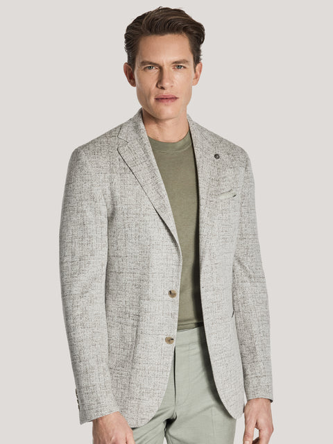 Tan melange blazer with notch lapels and button front worn over olive t-shirt.