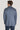 Man wearing sky blue melange blazer with notch lapels, shown from back view.