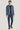 Man wearing sky blue and burnt orange plaid blazer with notched lapels over black shirt and navy trousers.