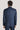 Mid blue pinstriped double breasted suit jacket with white shirt collar, shown from back view.